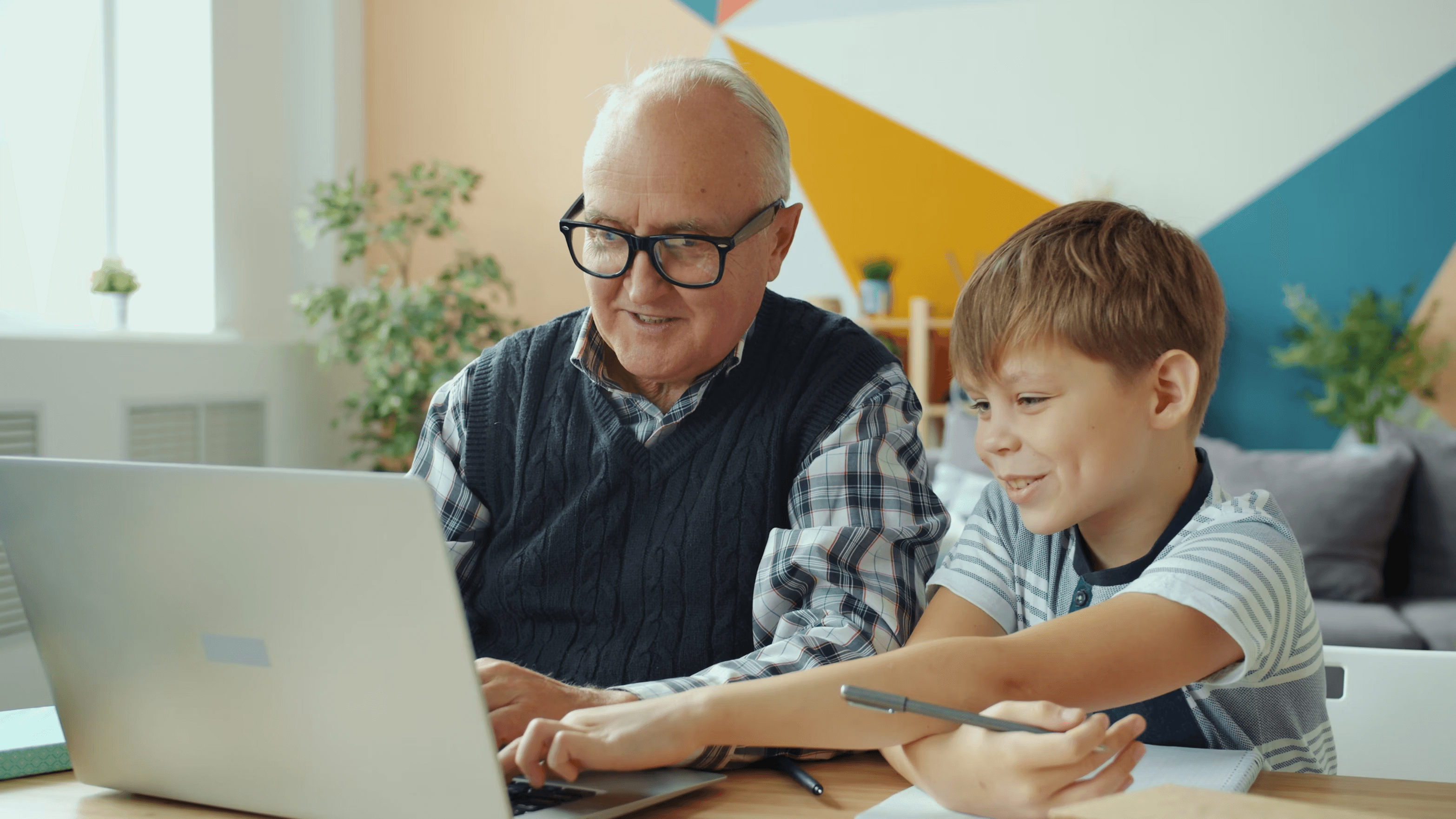 Senior man and child using a laptop together